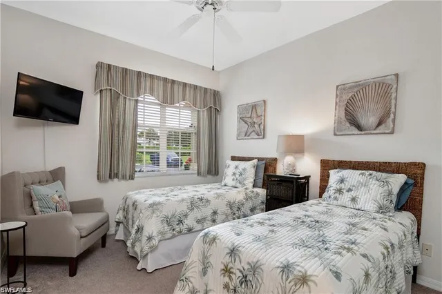 a bedroom with two beds and a couch