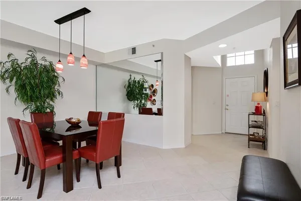 a dining room with furniture and wooden floor