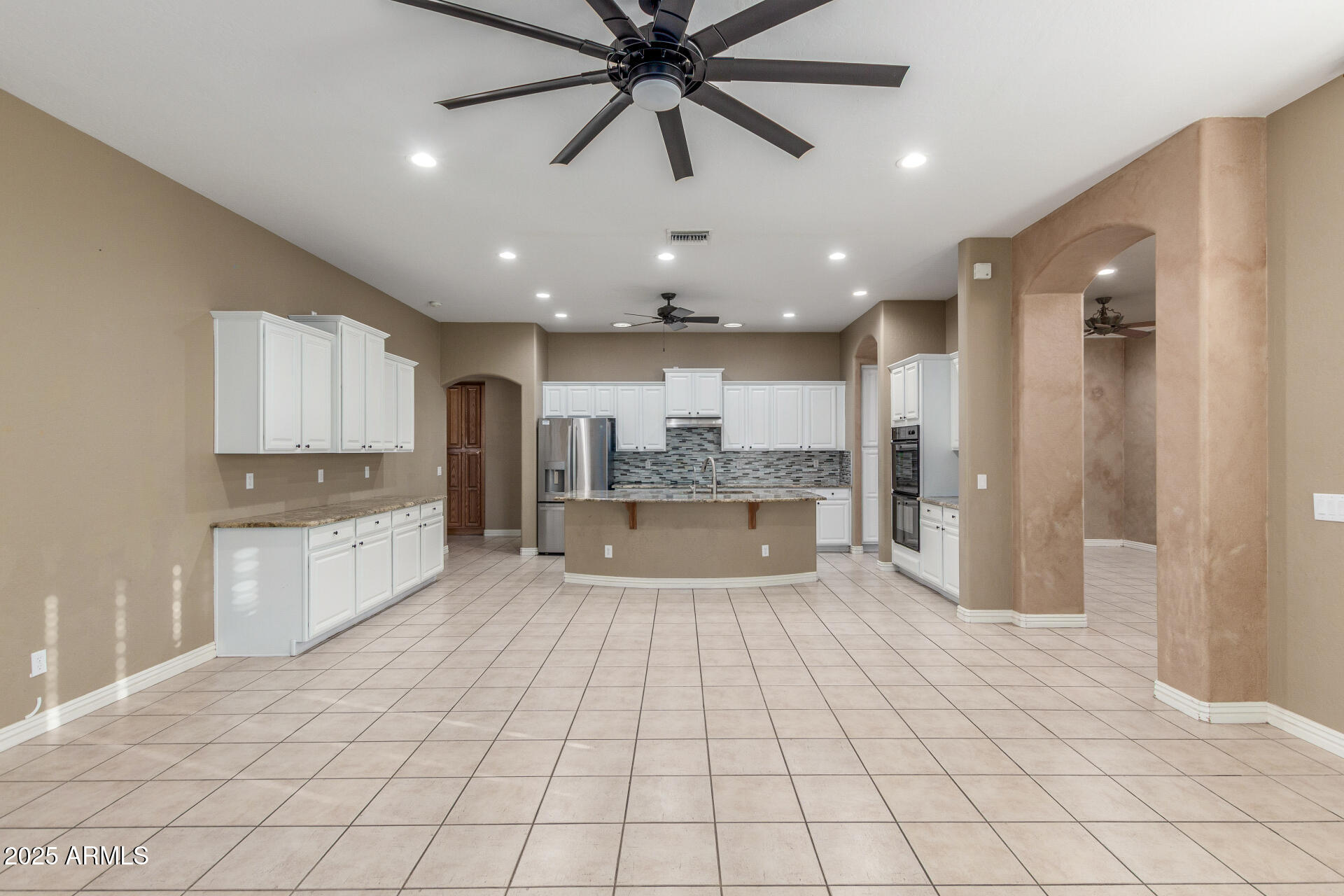 14380 West Monte Vista Road Goodyear, AZ 85395 - Photo 11 of 37 a large kitchen with stainless steel appliances lots of counter space and cabinets