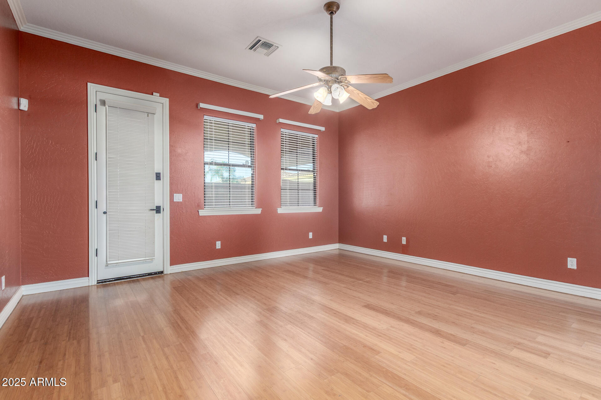 14380 West Monte Vista Road Goodyear, AZ 85395 - Photo 16 of 37 a view of an empty room with wooden floor and a window