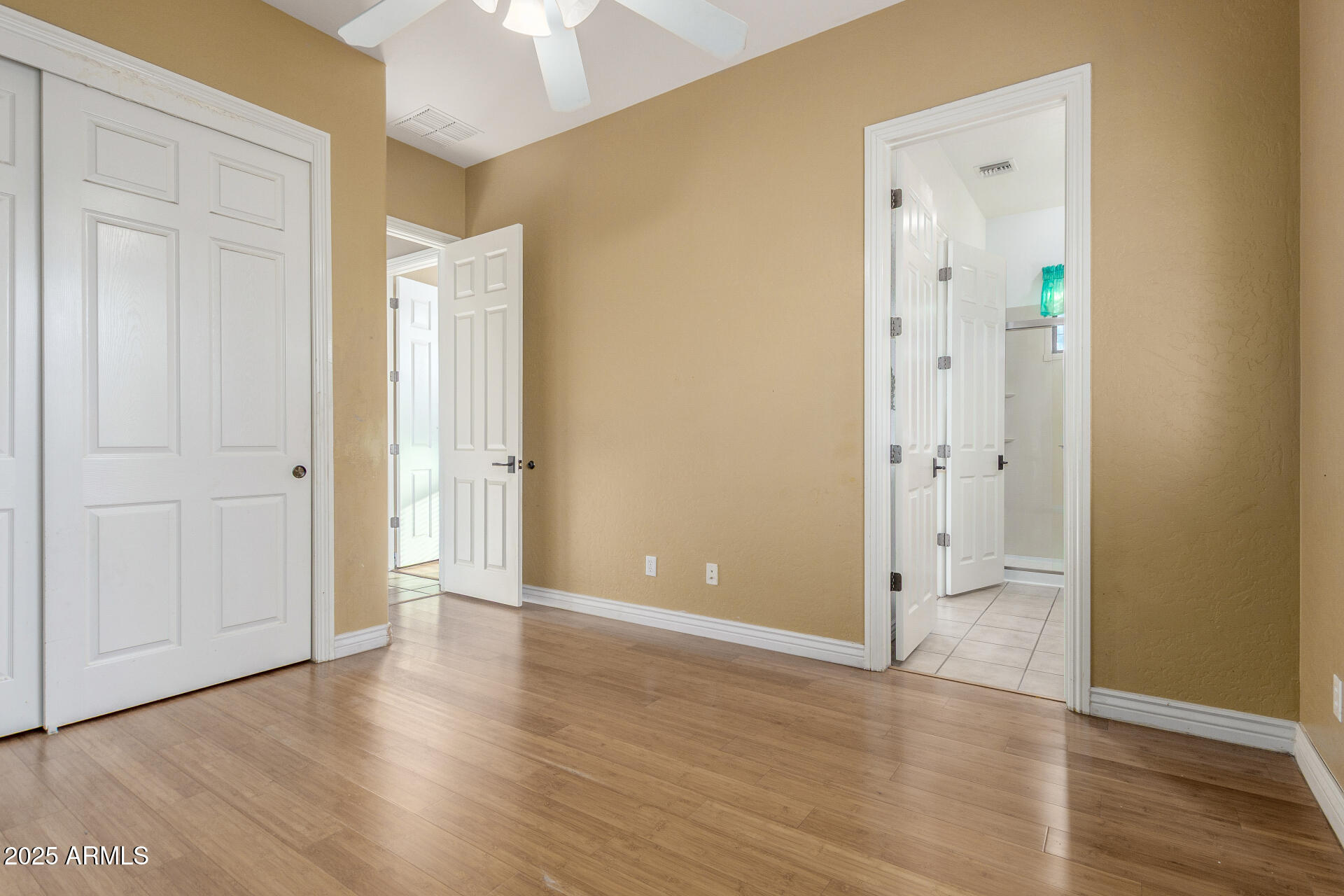 14380 West Monte Vista Road Goodyear, AZ 85395 - Photo 25 of 37 a view of an empty room with wooden floor and a bathroom