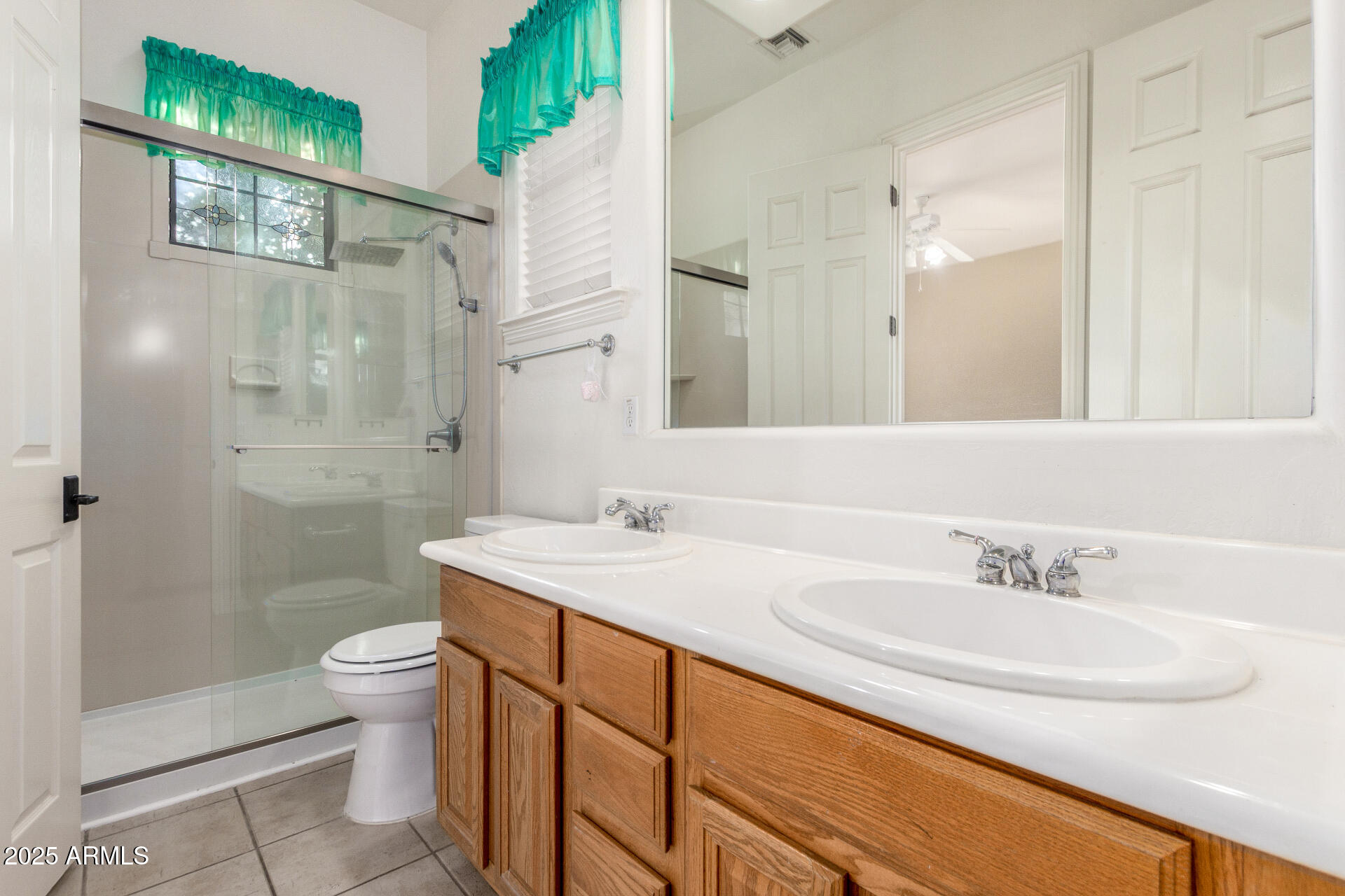 14380 West Monte Vista Road Goodyear, AZ 85395 - Photo 26 of 37 a bathroom with a sink and a mirror