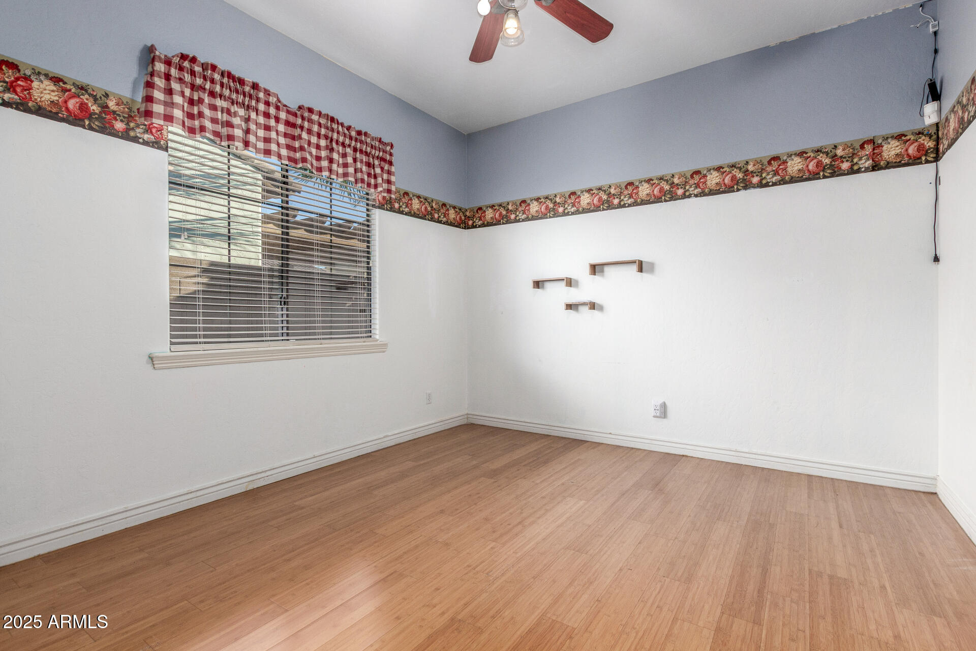 14380 West Monte Vista Road Goodyear, AZ 85395 - Photo 27 of 37 a view of an empty room with wooden floor and a window