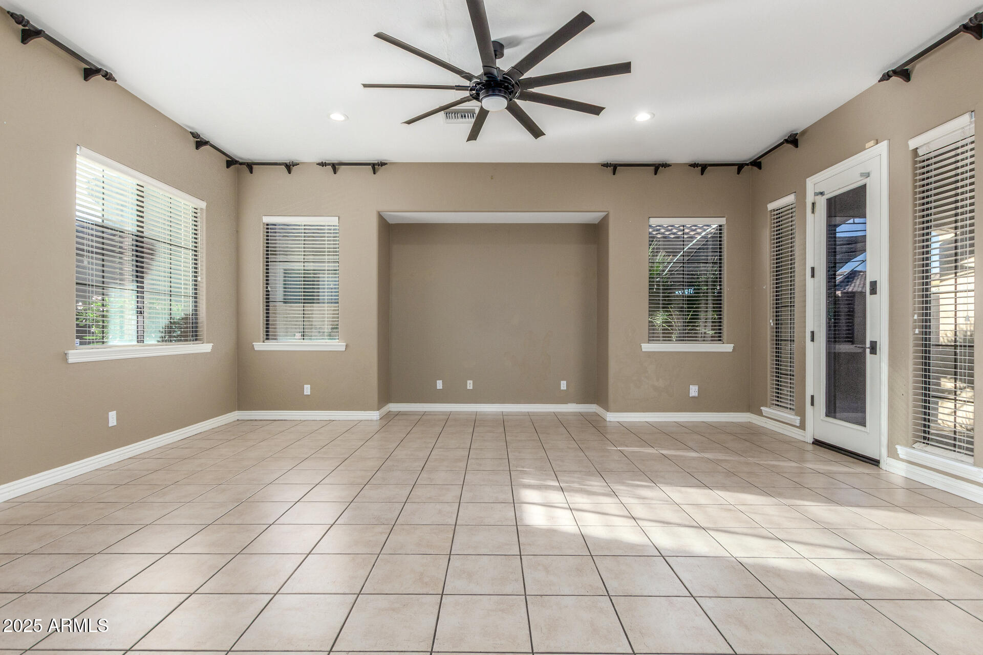 14380 West Monte Vista Road Goodyear, AZ 85395 - Photo 9 of 37 a view of an empty room with a window and a kitchen