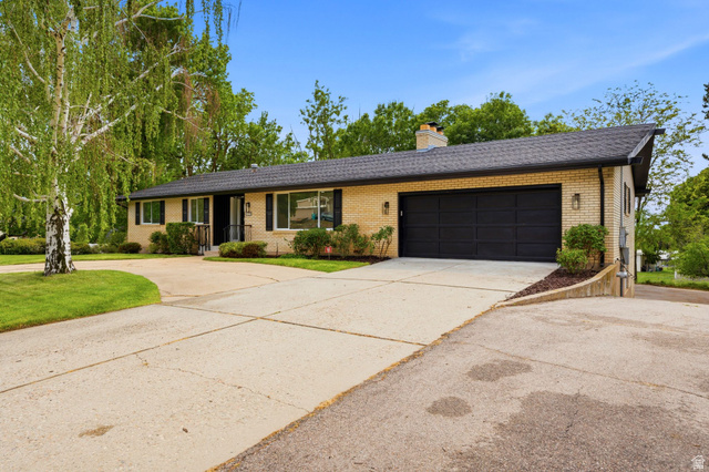871 Bonita Way Centerville, UT 84014 - Photo 45 of 61 Light-colored brick exterior with black shutters and a complementary black roof