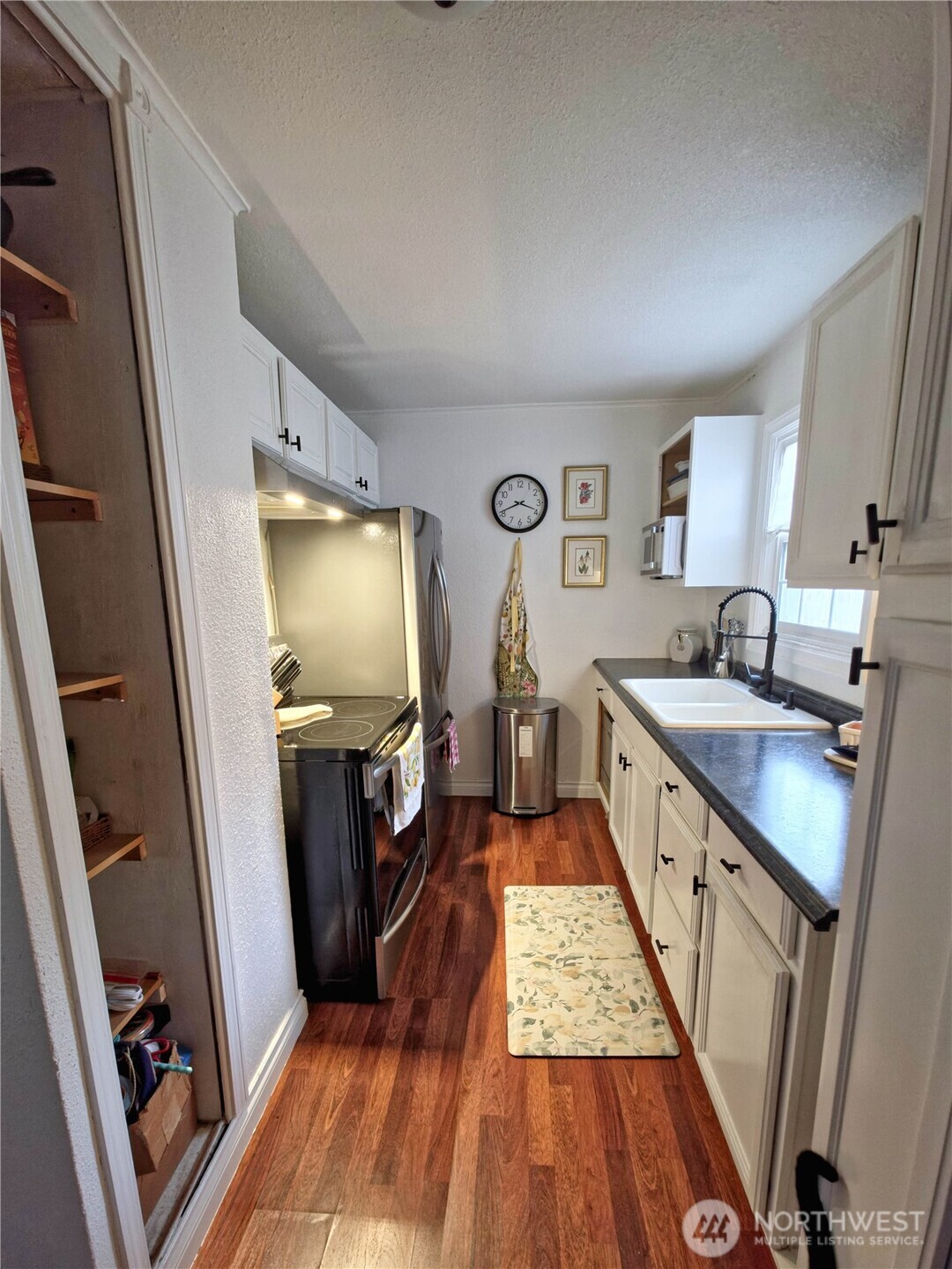 212 Douglas Street Longview, WA 98632 - Photo 12 of 20 a kitchen with sink a refrigerator and wooden floor