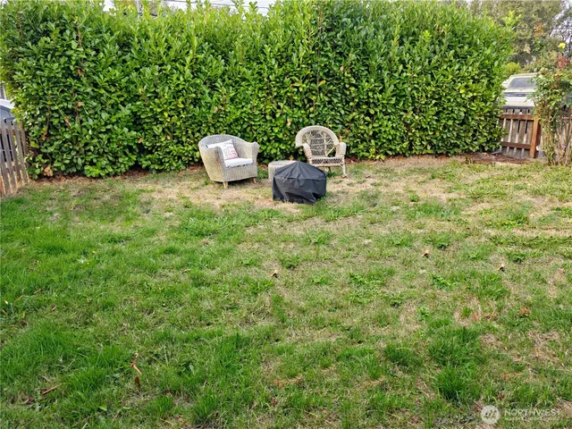 a backyard of a house with table and chairs
