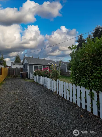 a view of a garden with wooden fence