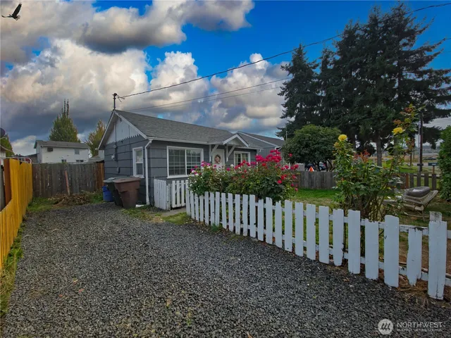 a view of a house with wooden fence