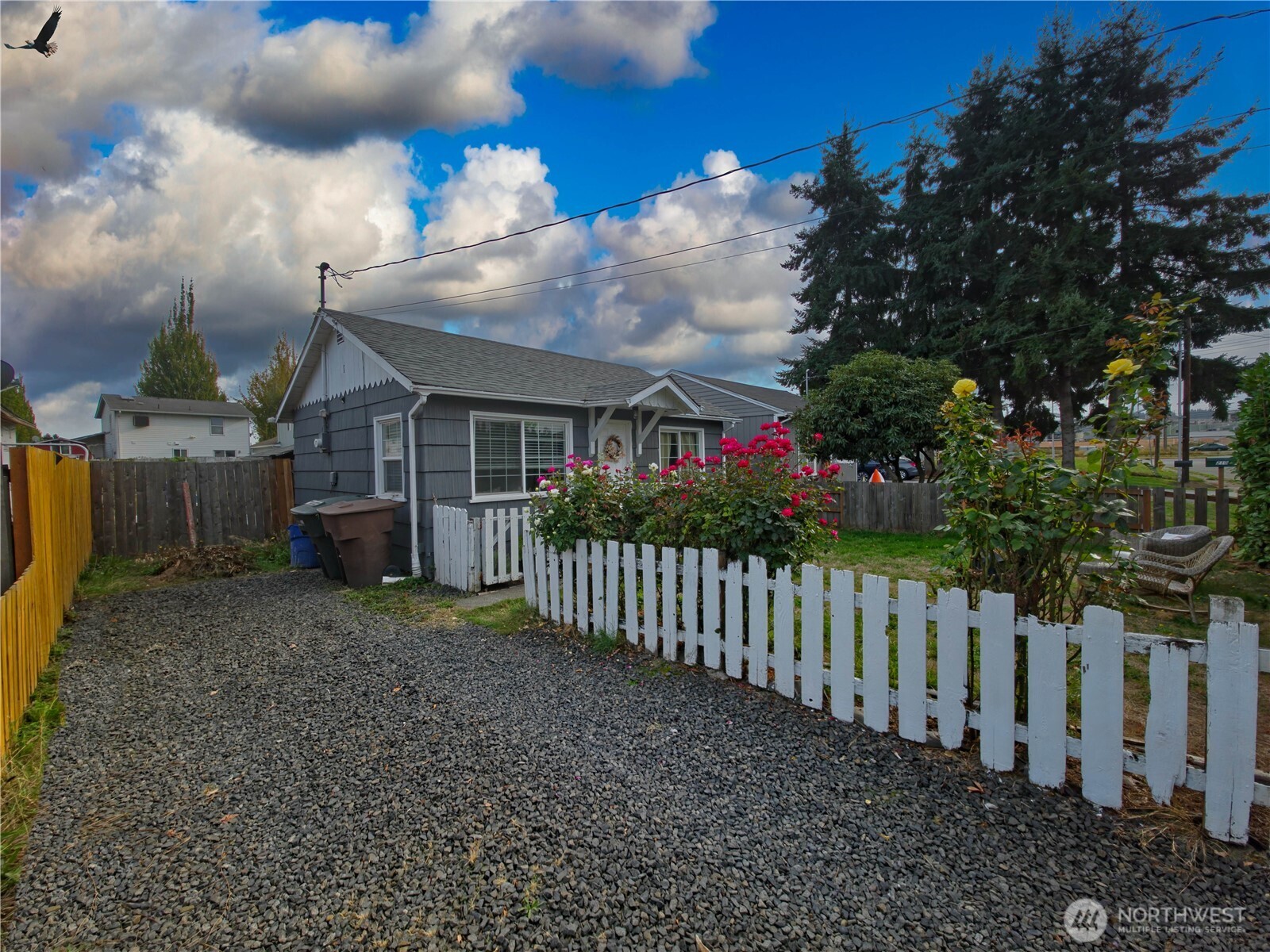 212 Douglas Street Longview, WA 98632 - Photo 3 of 20 a view of a house with wooden fence