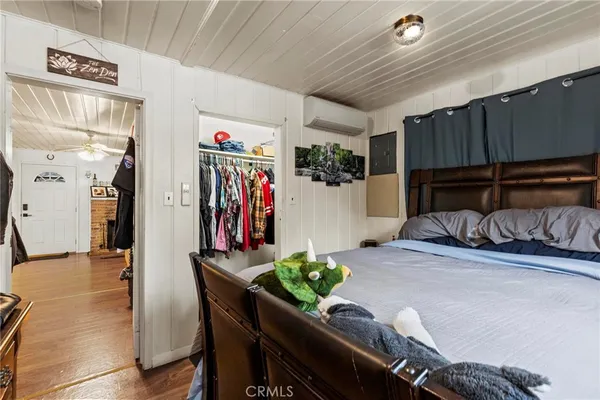 a bedroom with furniture and a closet