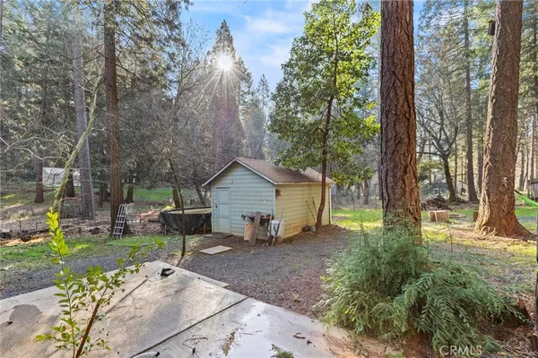 a view of a house with backyard and sitting area