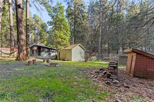 a small barn in middle of the green field