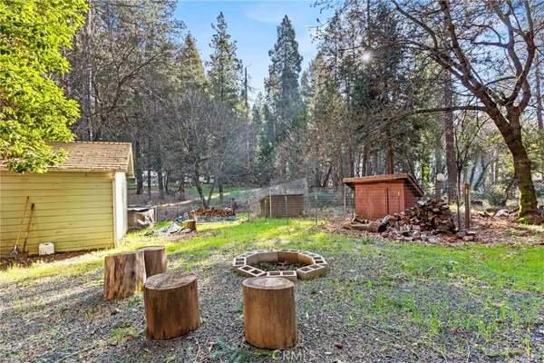 a view of a backyard with sitting area and fire pit