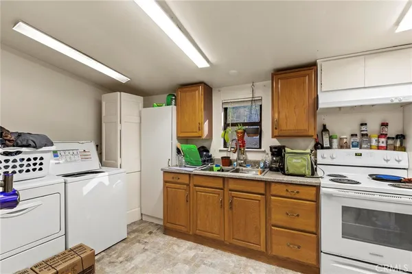 a kitchen with sink cabinets and appliances