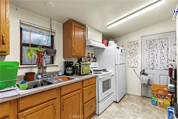 a kitchen with a sink stove and refrigerator