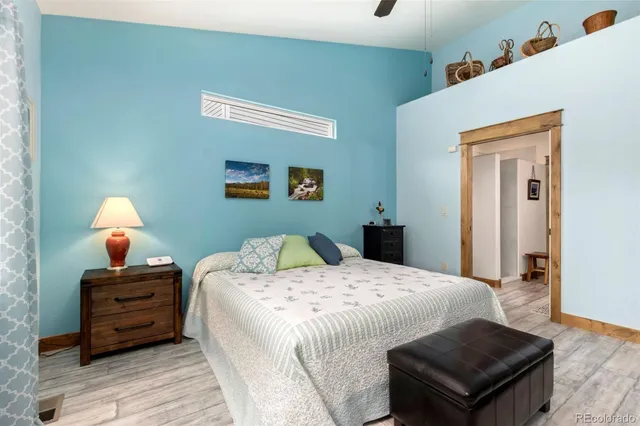 a view of a hallway with wooden floor and furniture