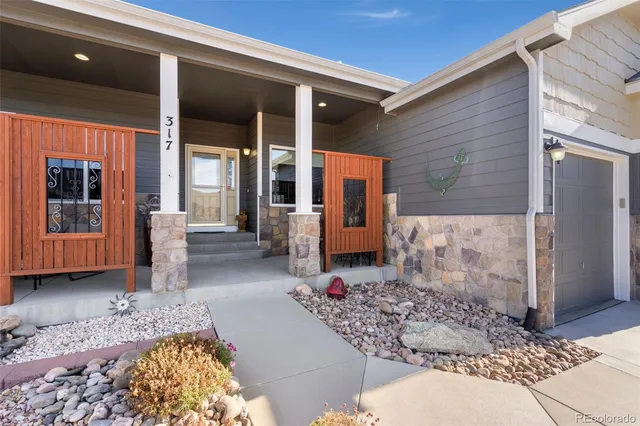 a view of living room with patio furniture and windows