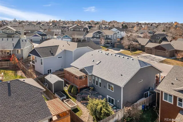 a view of a patio with chairs and potted plants