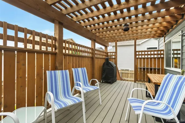 an aerial view of ocean and residential houses with outdoor space