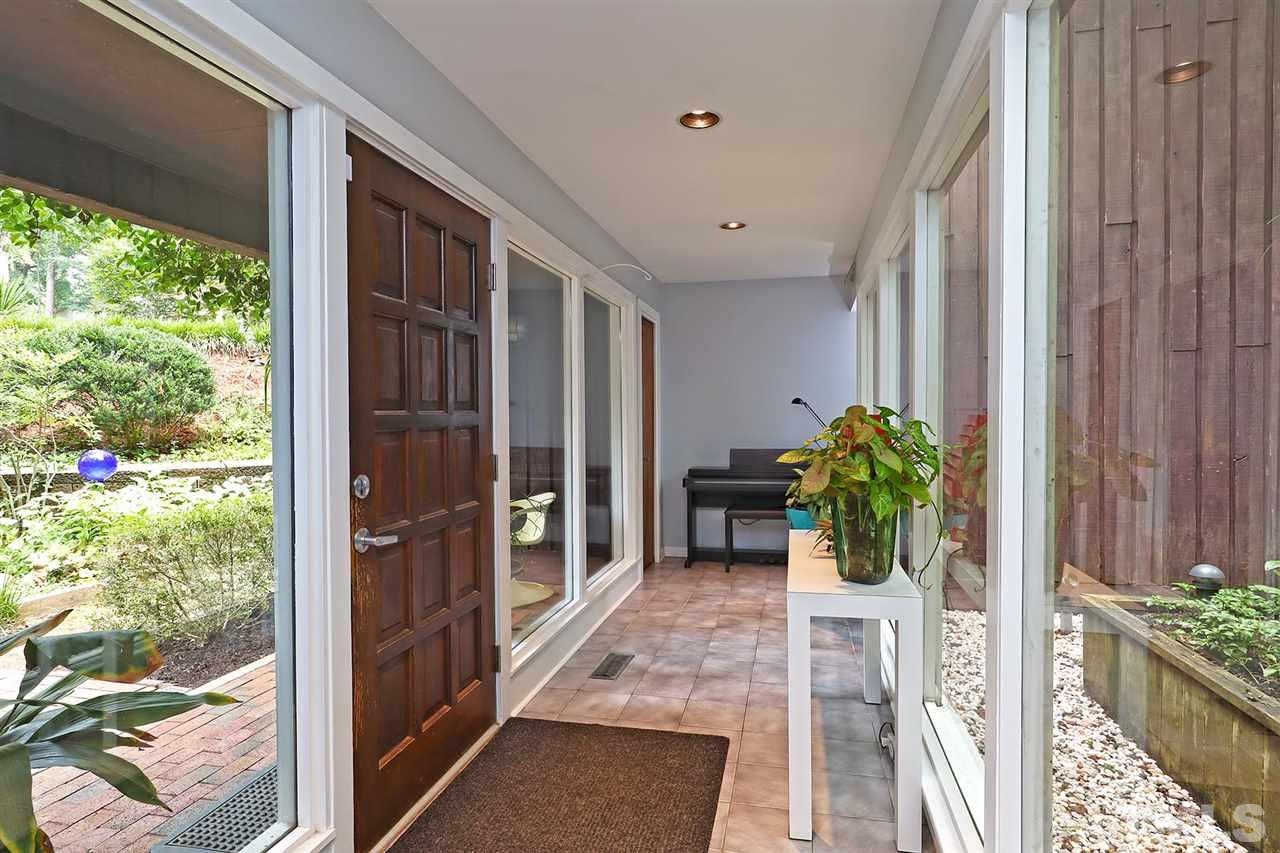4613 Oak Park Road Raleigh, NC 27612 - Photo 2 of 25 a view of a porch with chairs and potted plants