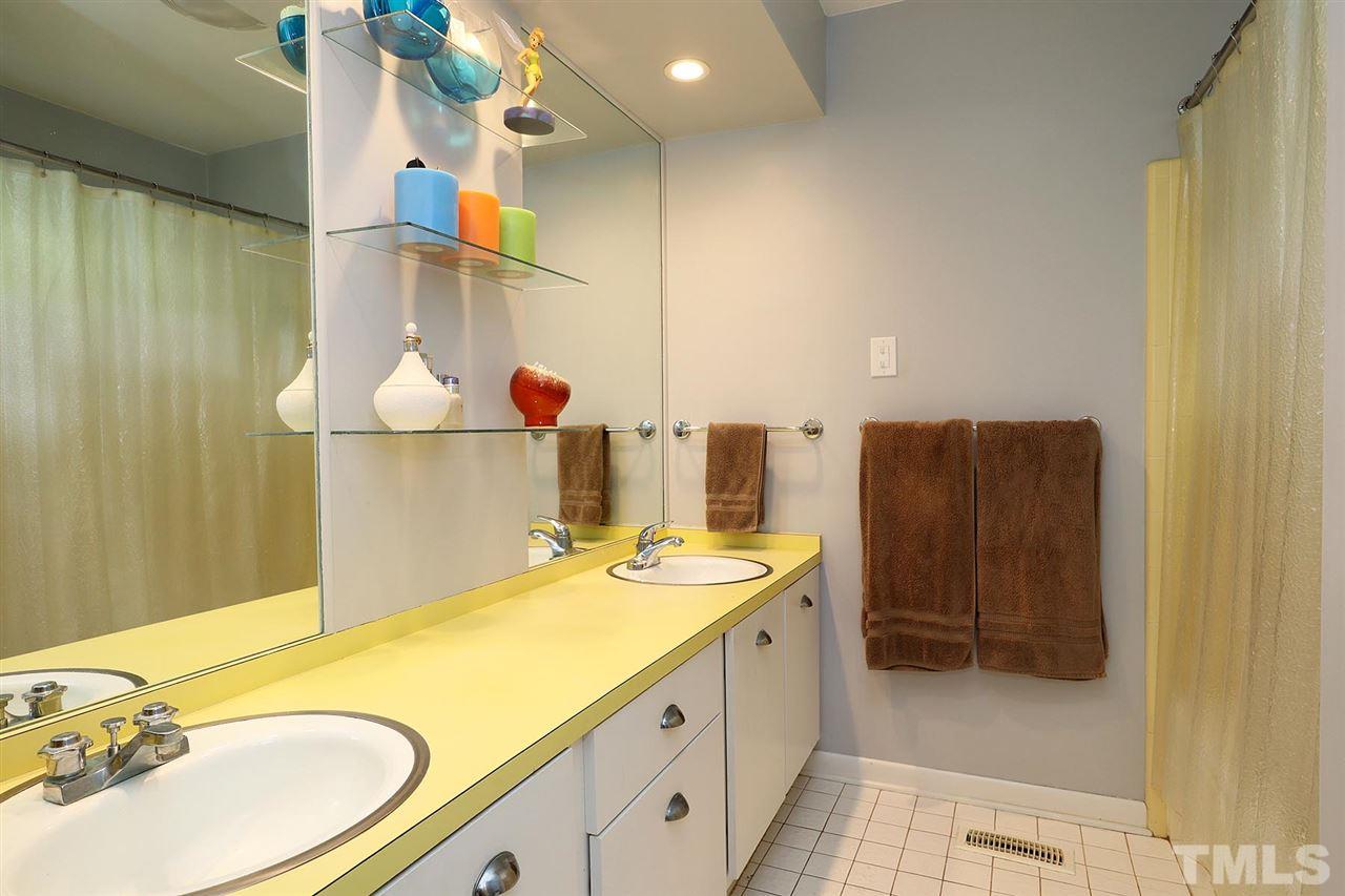 4613 Oak Park Road Raleigh, NC 27612 - Photo 11 of 25 a bathroom with a sink and a mirror