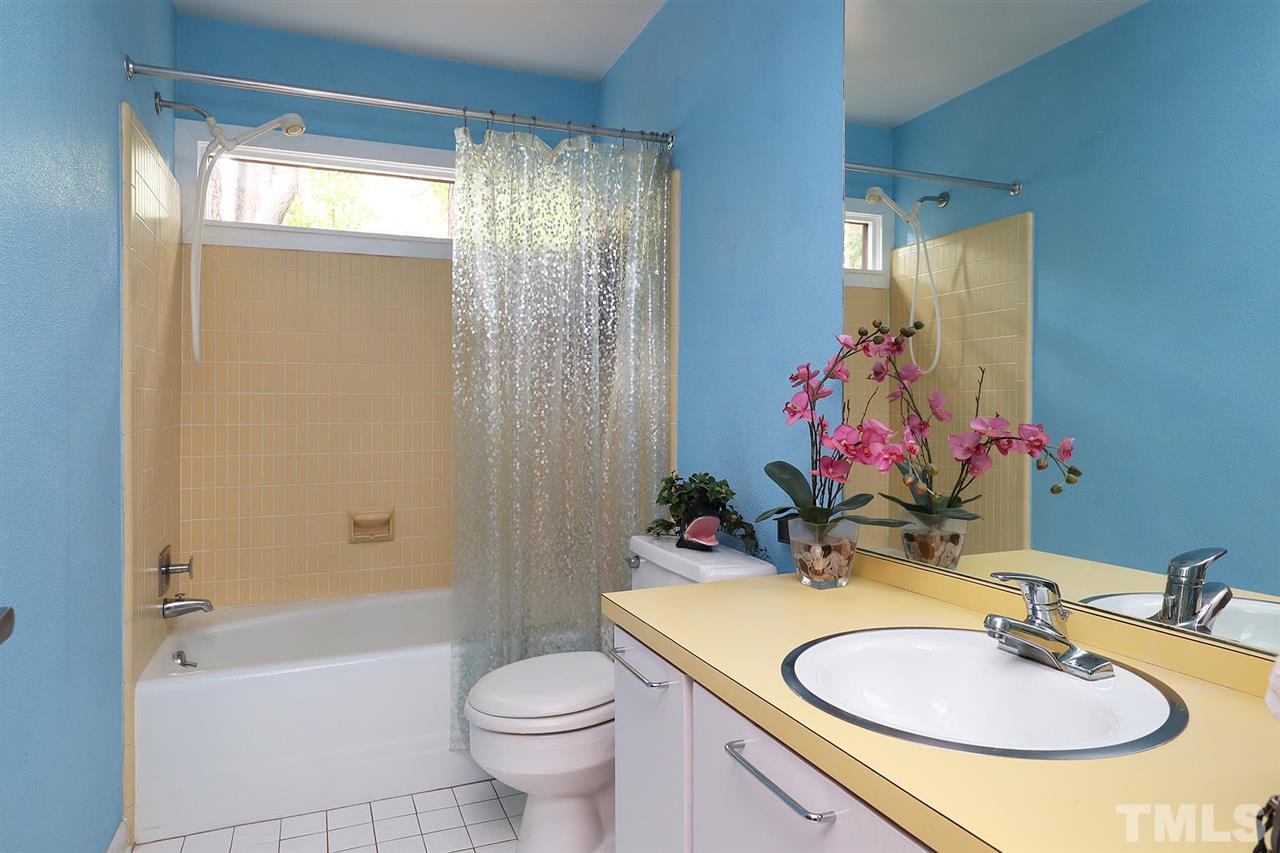 4613 Oak Park Road Raleigh, NC 27612 - Photo 13 of 25 a bathroom with a sink toilet and shower