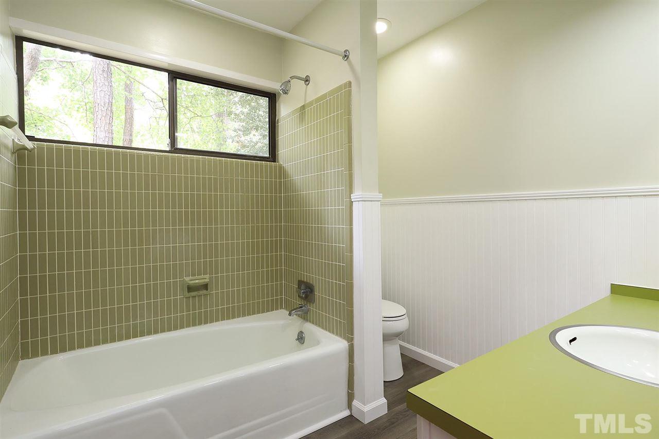 4613 Oak Park Road Raleigh, NC 27612 - Photo 16 of 25 a bathroom with a bathtub sink and toilet