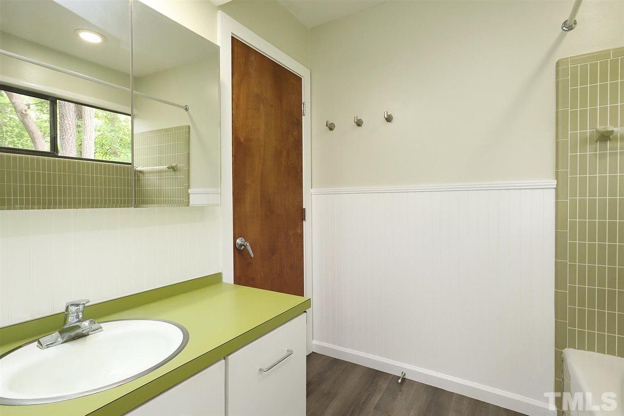 4613 Oak Park Road Raleigh, NC 27612 - Photo 17 of 25 a bathroom with a sink and a mirror