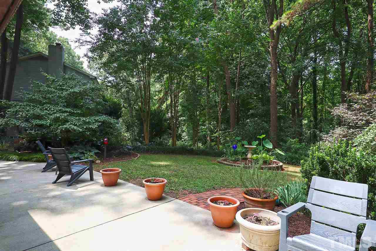 4613 Oak Park Road Raleigh, NC 27612 - Photo 21 of 25 a view of a backyard with table and chairs potted plants and a fire pit