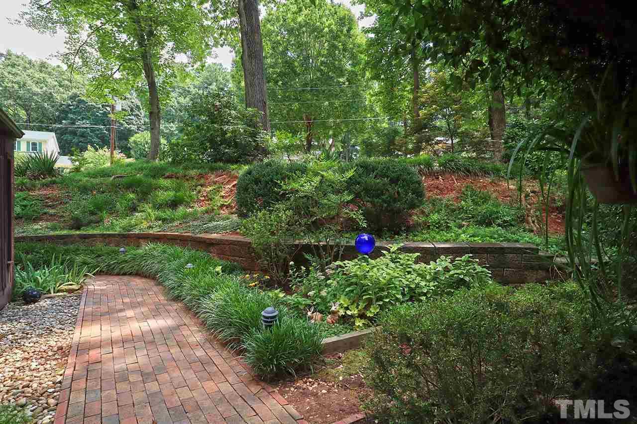 4613 Oak Park Road Raleigh, NC 27612 - Photo 22 of 25 a view of a garden with flowers and trees