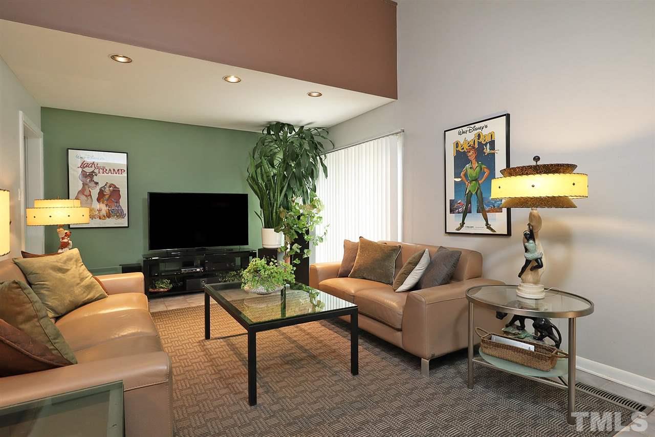 4613 Oak Park Road Raleigh, NC 27612 - Photo 4 of 25 a living room with furniture and a flat screen tv
