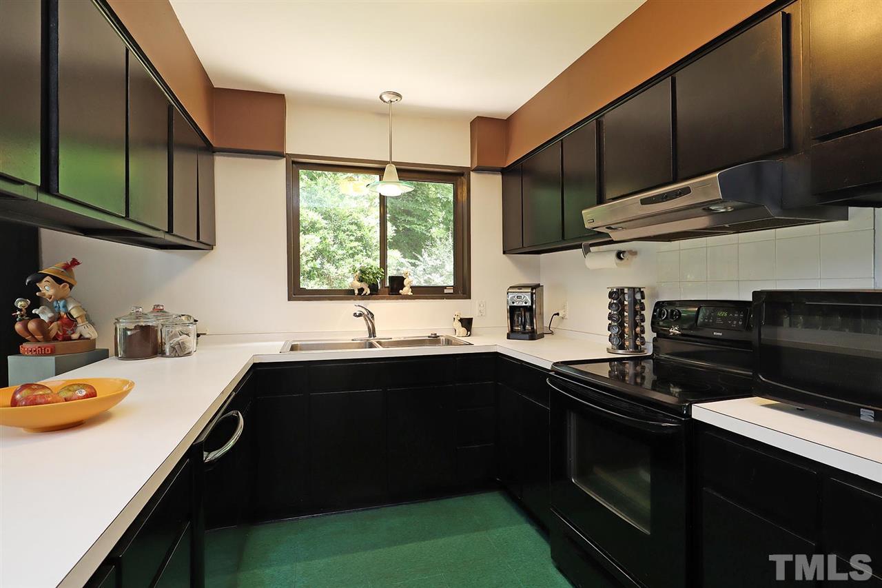 4613 Oak Park Road Raleigh, NC 27612 - Photo 7 of 25 a kitchen with a sink stove and cabinets