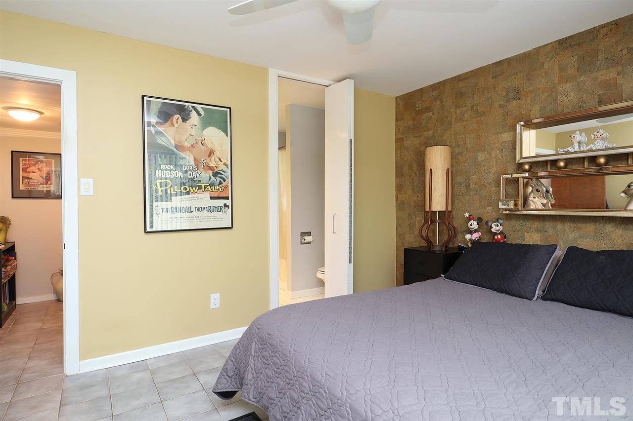 4613 Oak Park Road Raleigh, NC 27612 - Photo 10 of 25 a bedroom with a bed and wooden floor