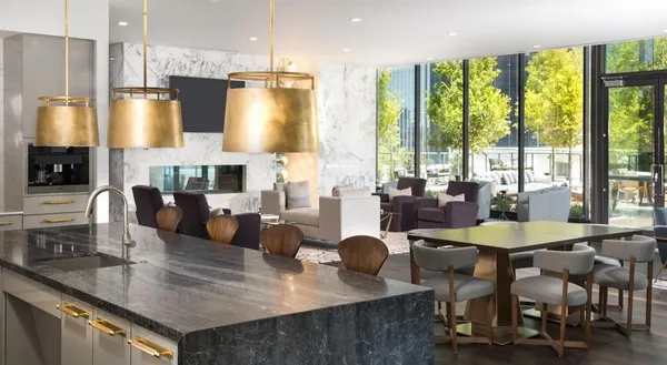 a large kitchen with a table chairs refrigerator and a sink