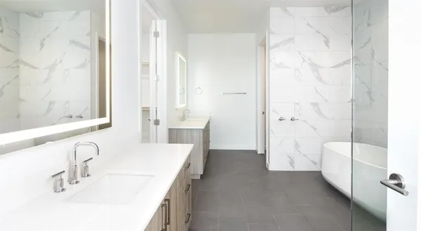 a bathroom with a tub sink and shower