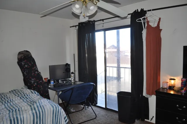 a view of a workspace with furniture and a window