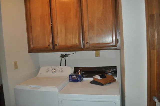 a close view of a utility room with dryer and washer