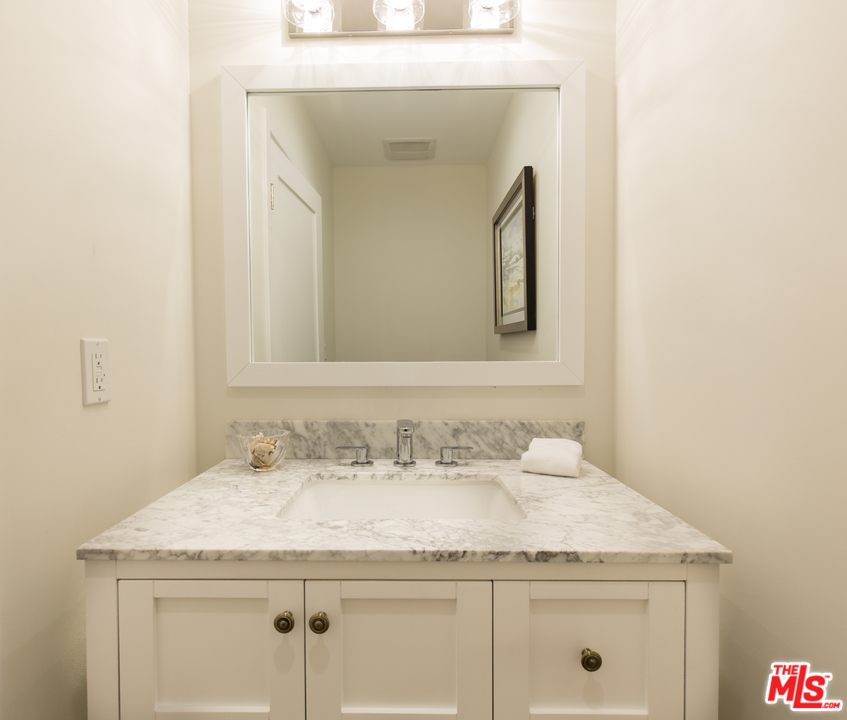 905 Lucille Avenue Venice, CA 90291 - Photo 14 of 24 a bathroom with a granite countertop sink and a mirror