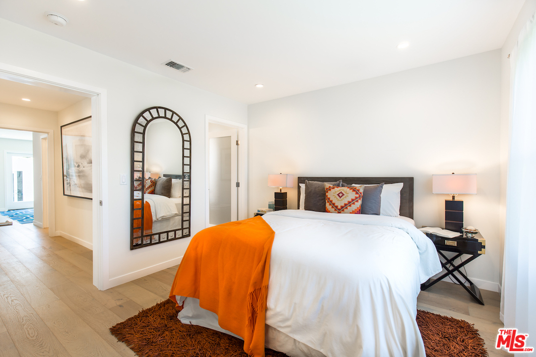 905 Lucille Avenue Venice, CA 90291 - Photo 15 of 24 a bedroom with a bed and wooden floor