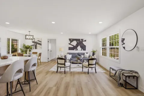 a dining room with furniture a flat screen tv and a large window