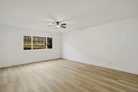 wooden floor in an empty room with a window