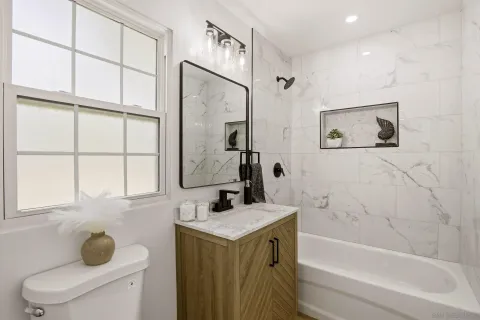 a bathroom with a tub sink and mirror