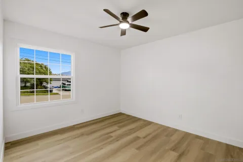 a view of empty room with ceiling fan