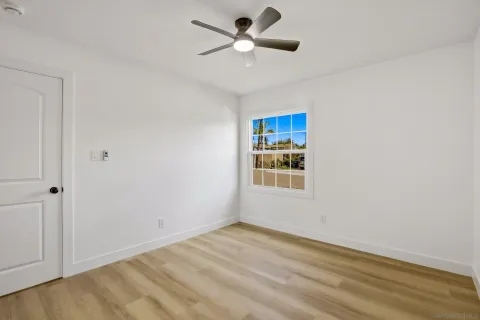 a view of a room with a window and a ceiling fan