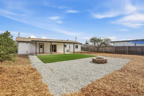 a view of a white house with a yard