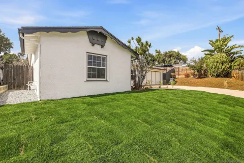 a view of a backyard with plants and a patio