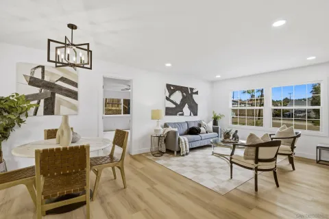 a living room with furniture and a floor to ceiling window