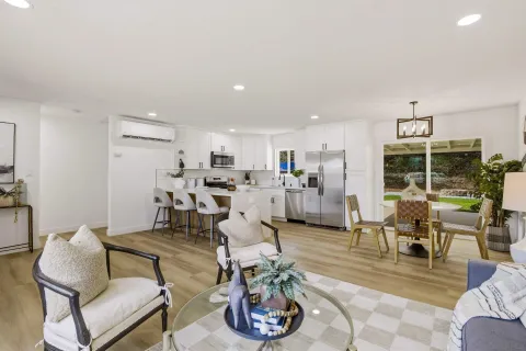 a living room with furniture kitchen and a table