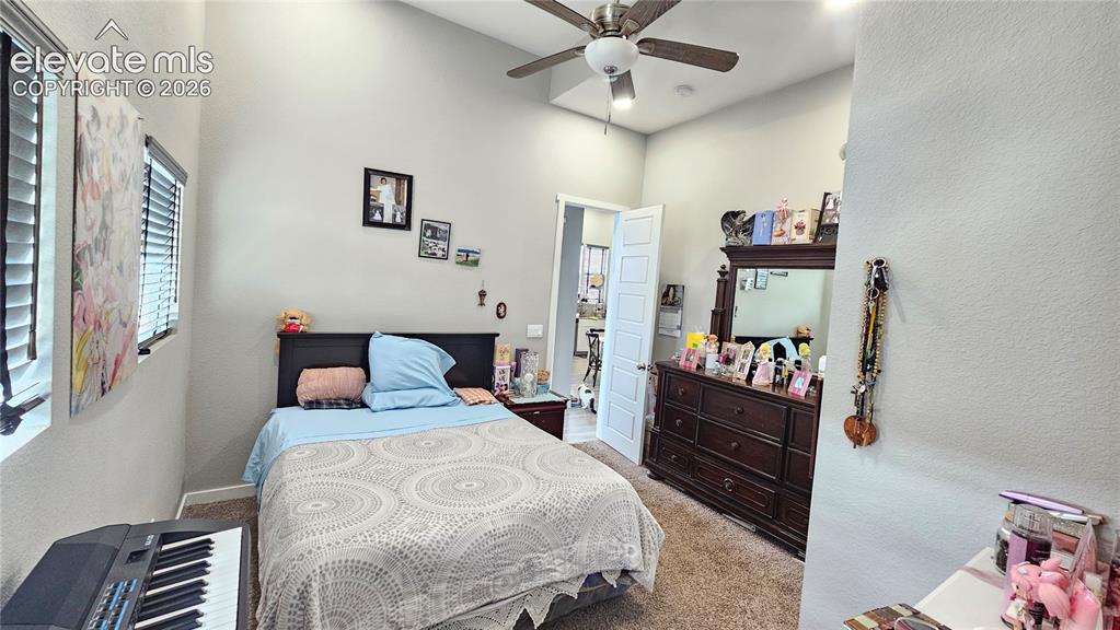 3835 Sengbeil Road Yoder, CO 80864 - Photo 26 of 48 a bedroom with a bed and a chandelier